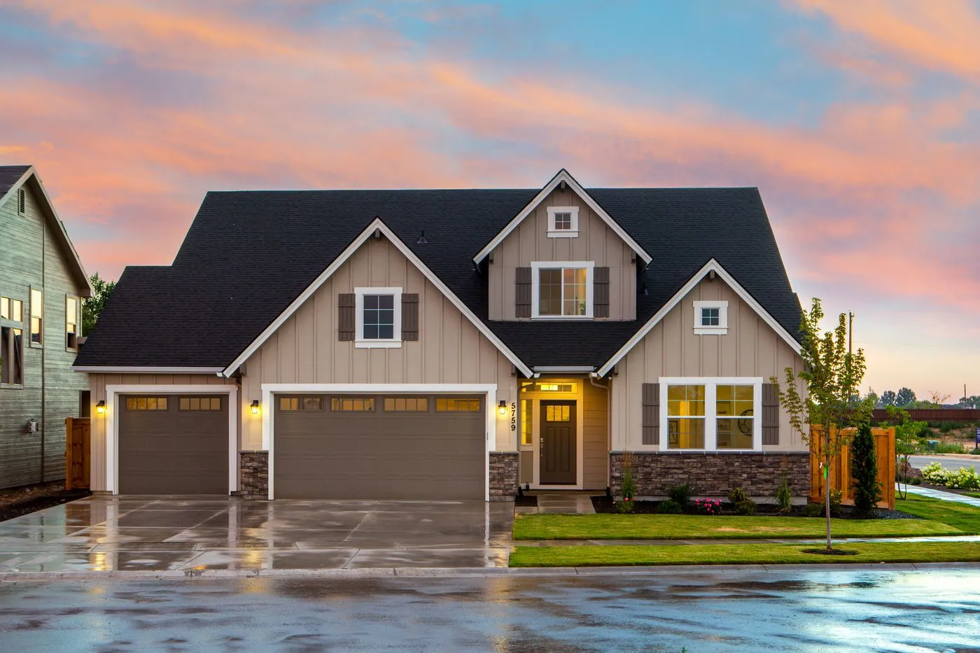 Home with an illuminated garage door at dusk in Oconee County